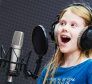 Recording vocal song or dubbing in studio. little girl singing in studio