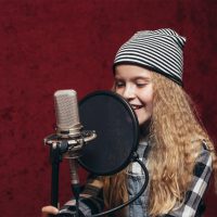 young girl singing in studio